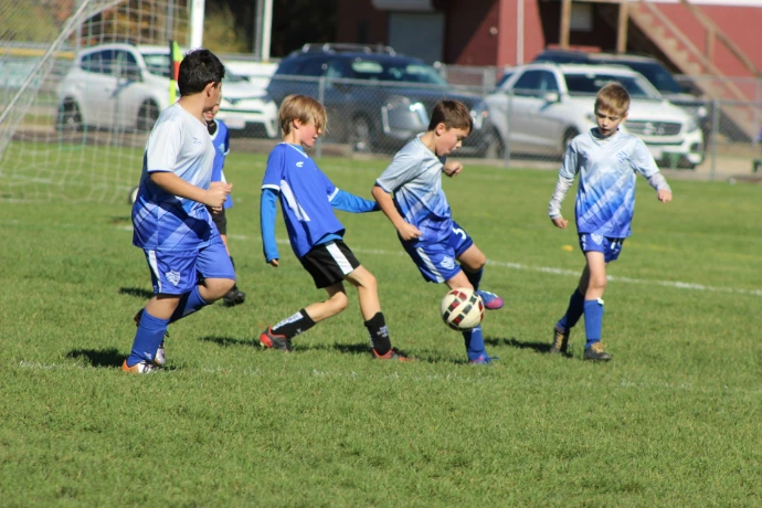 a group of young boys playing a game of soccer